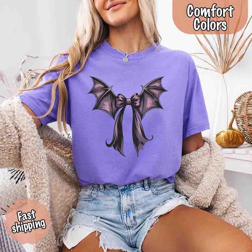 Purple T-shirt worn with black bat bow wings graphic on the chest