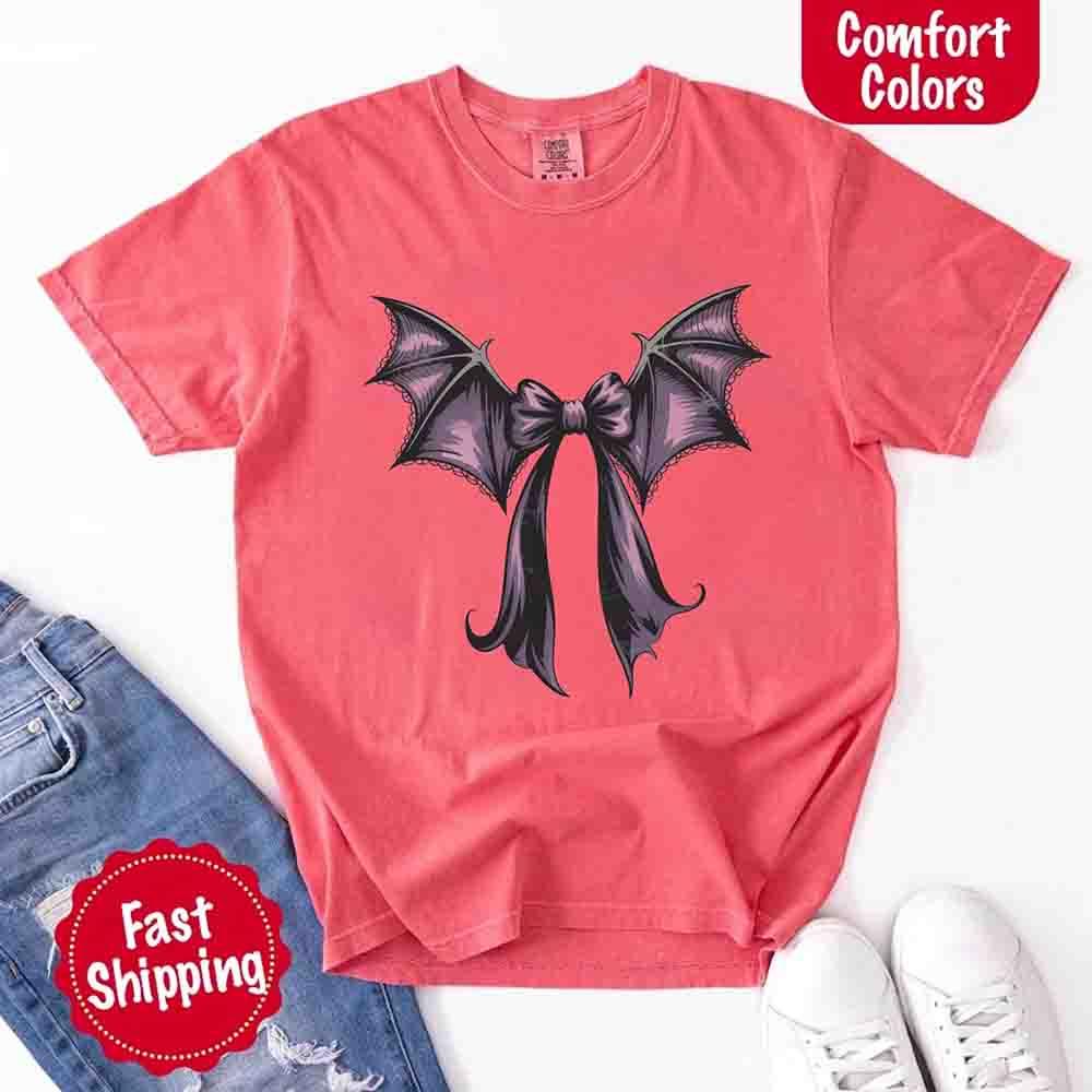 Pink Halloween T-shirt with black and purple bat bow graphic across the chest