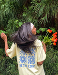 Yellow unisex T-shirt with blue sunburst graphic and BE THE LIGHT lettering