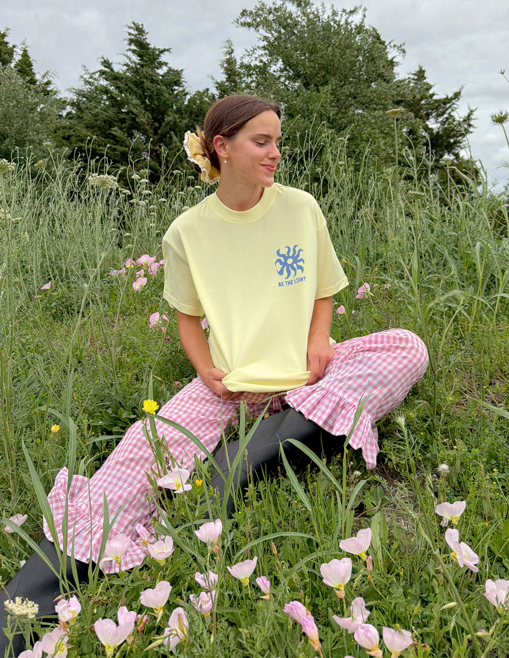 Yellow unisex T-shirt with blue sunburst logo and BE THE LIGHT lettering