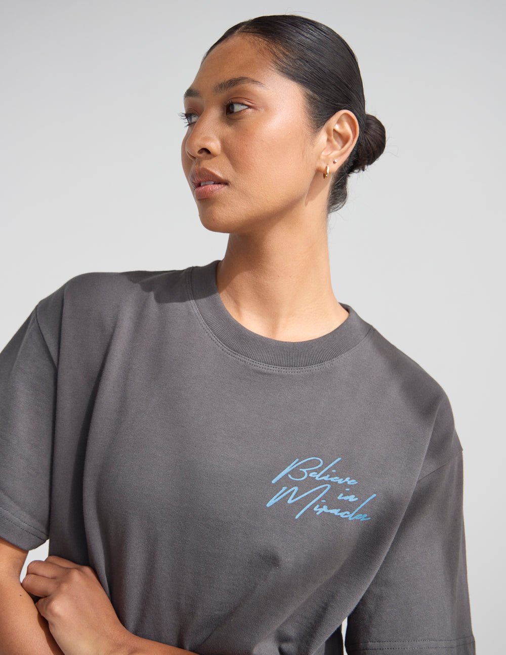 Dark gray crew-neck T-shirt with cursive front logo