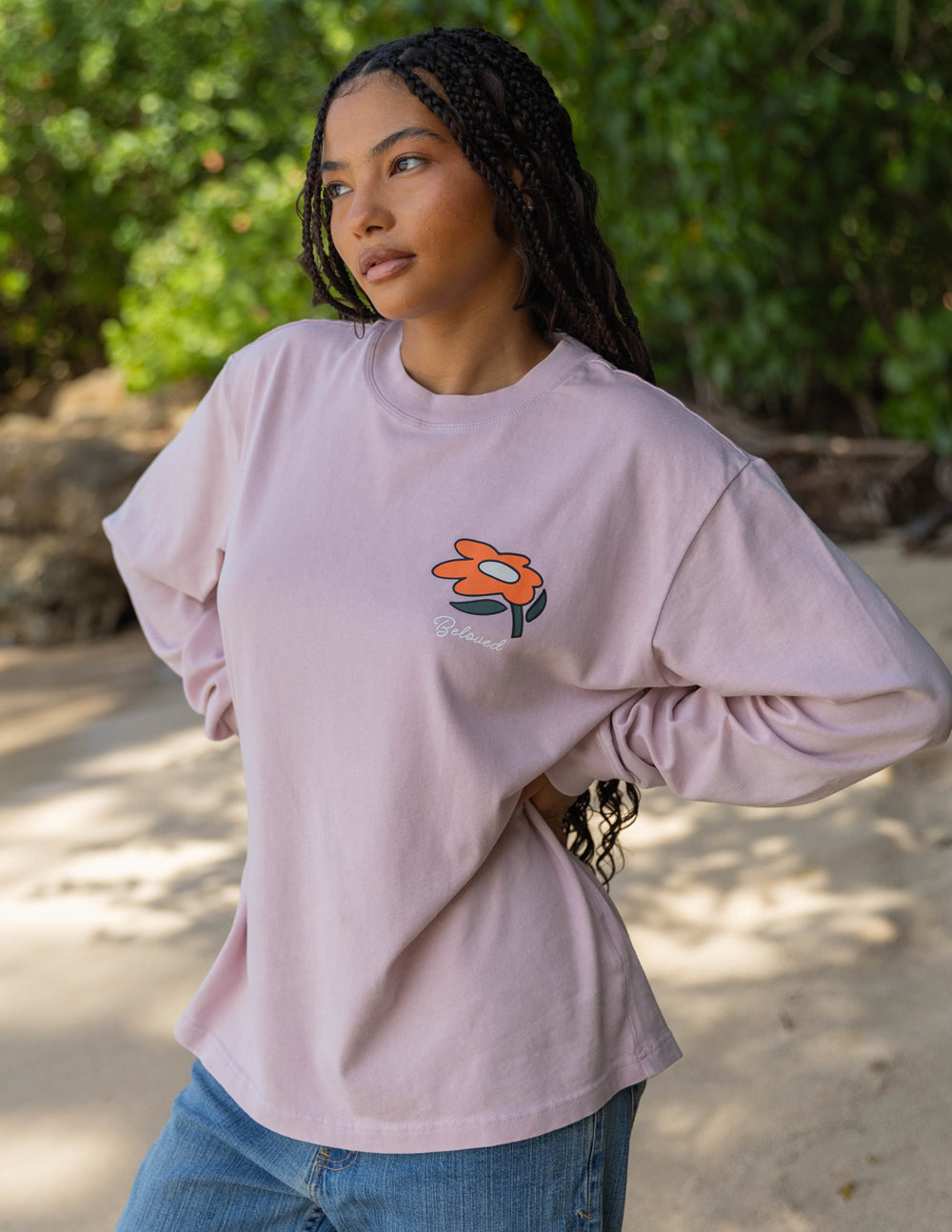Light purple long-sleeve unisex tee with orange flower logo on chest