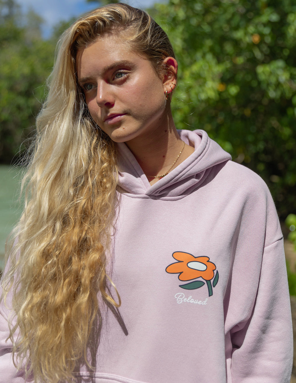 Lilac unisex hoodie with small floral logo on chest and 'Beloved' script
