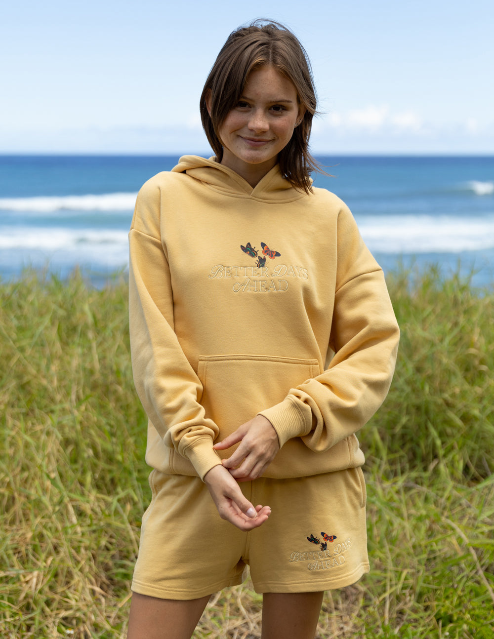 Unisex tan hoodie and matching shorts set with butterfly print on chest and legs