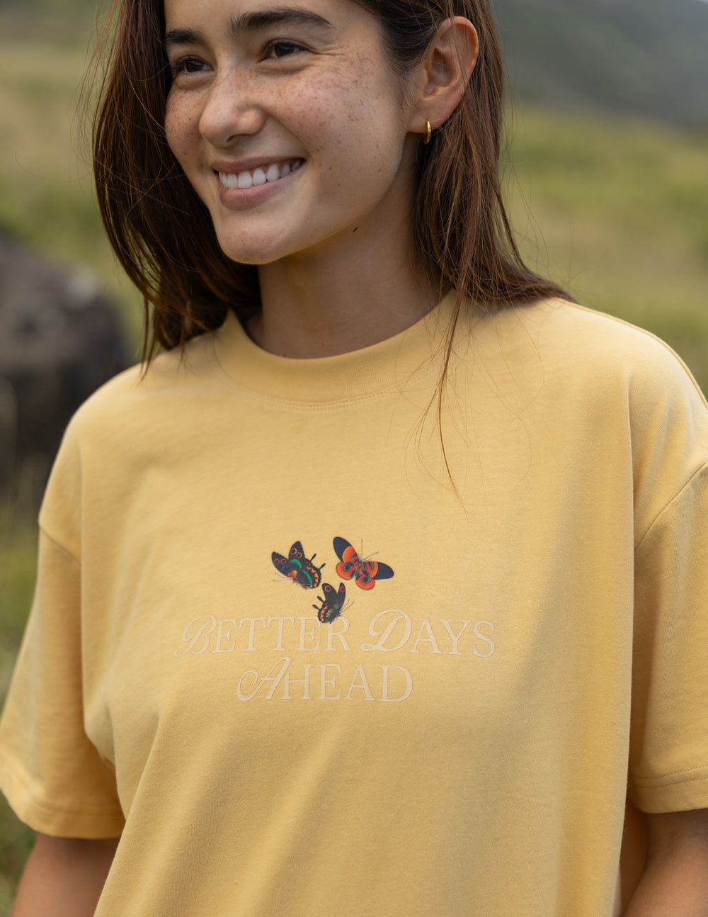 Yellow unisex T-shirt with small colorful butterfly graphic on chest