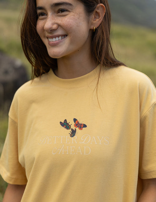 Yellow unisex T-shirt with small colorful butterfly graphic on chest
