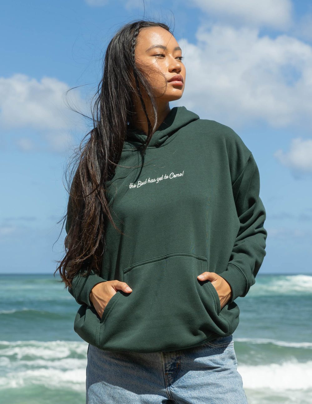Dark green unisex hoodie with hood and small chest logo; long sleeves
