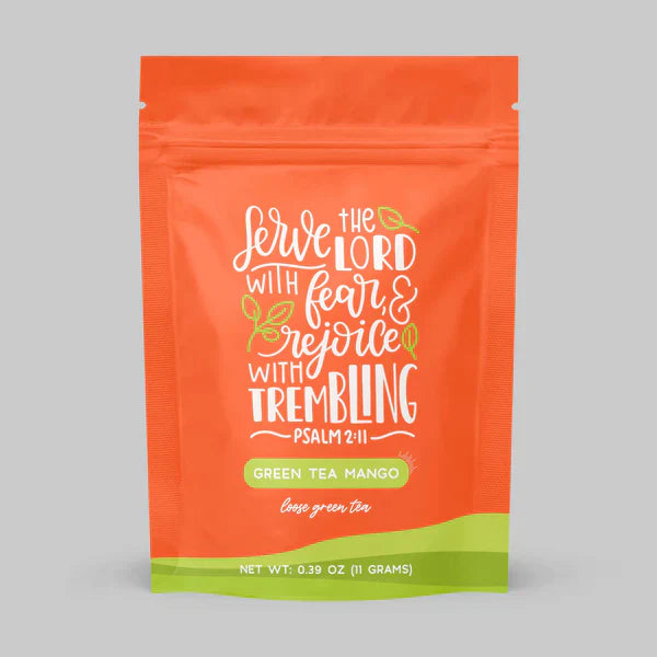 Orange tea pouch labeled green tea mango with quote text