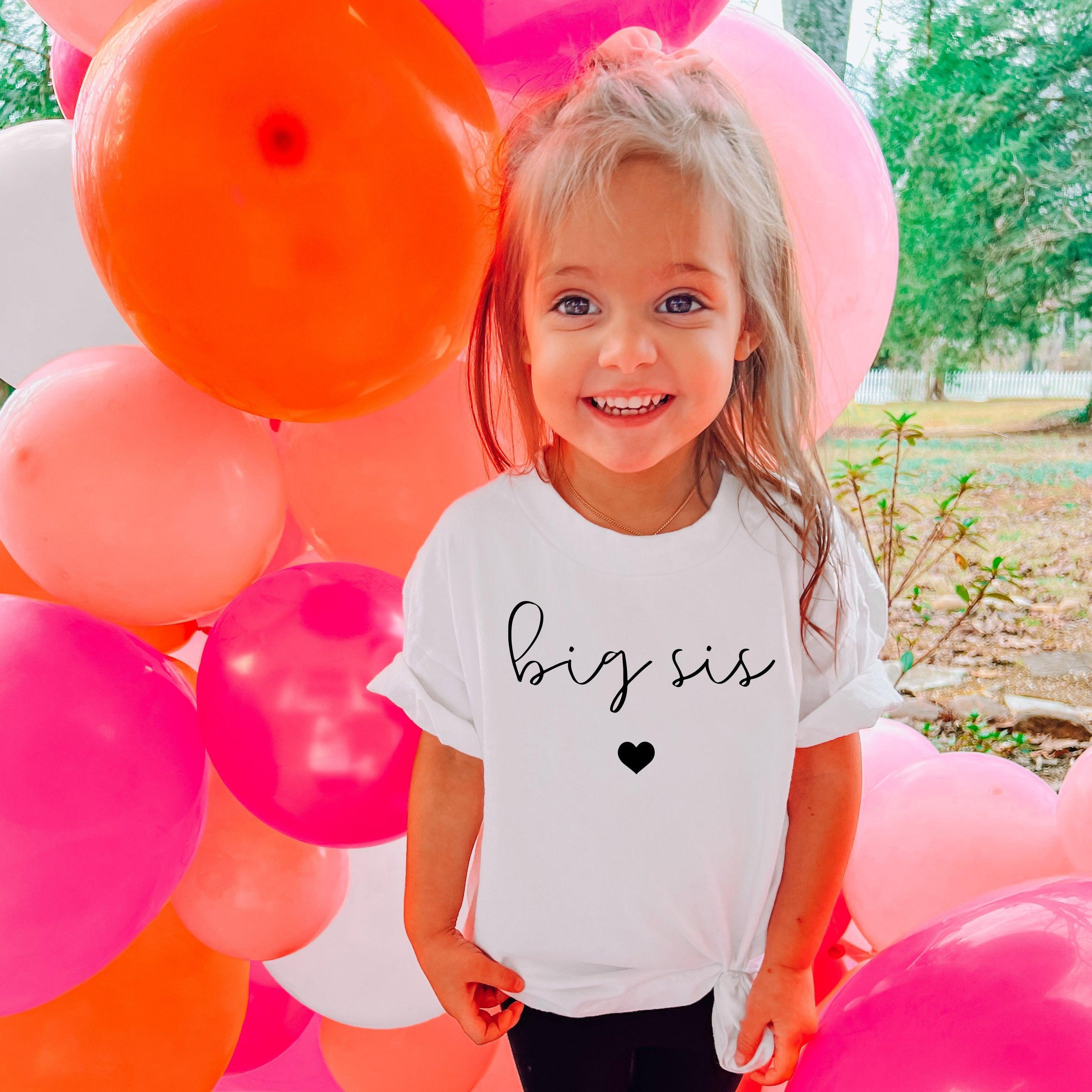 Baby and toddler big sis T-shirt, white with cursive text and small heart