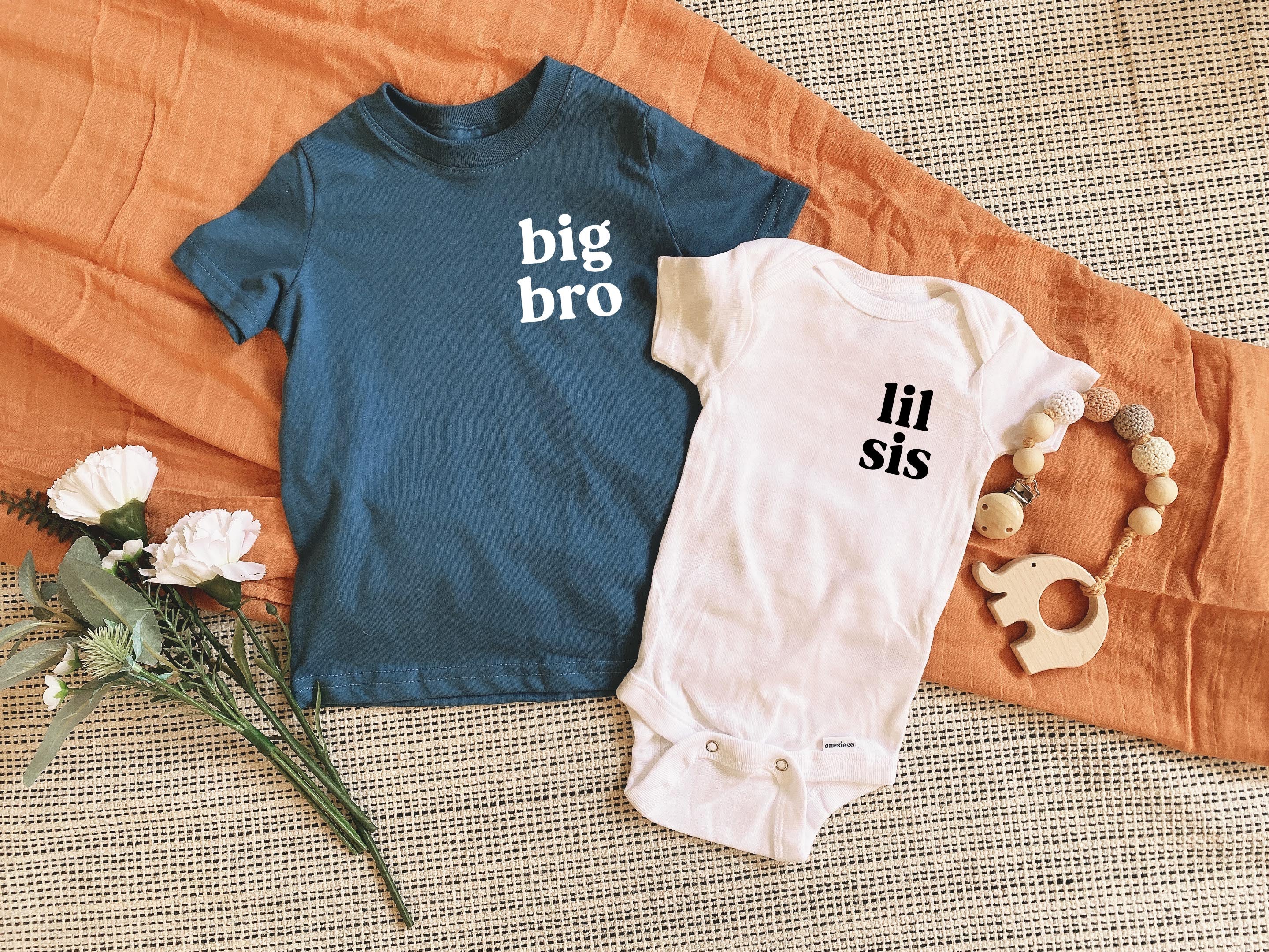 Sibling baby and toddler shirts: blue 'big bro' tee and white 'lil sis' bodysuit