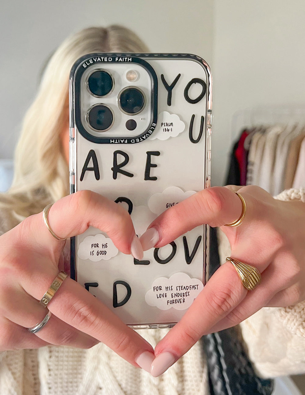 Clear phone case with black edges and “YOU ARE SO LOVED” message with cloud callouts
