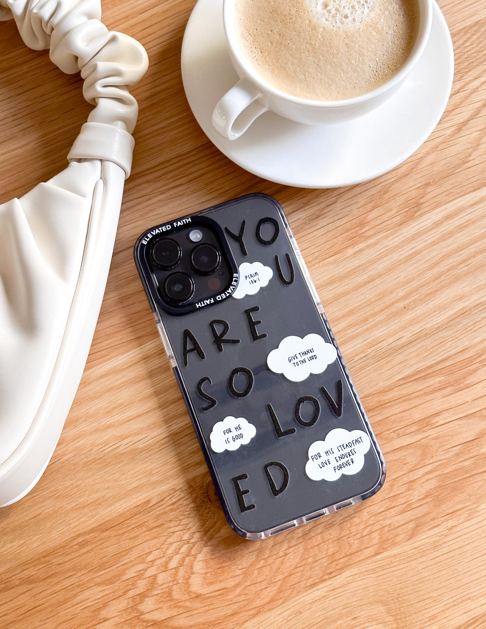 Clear phone case with black edges and “YOU ARE SO LOVED” quote in stacked letters