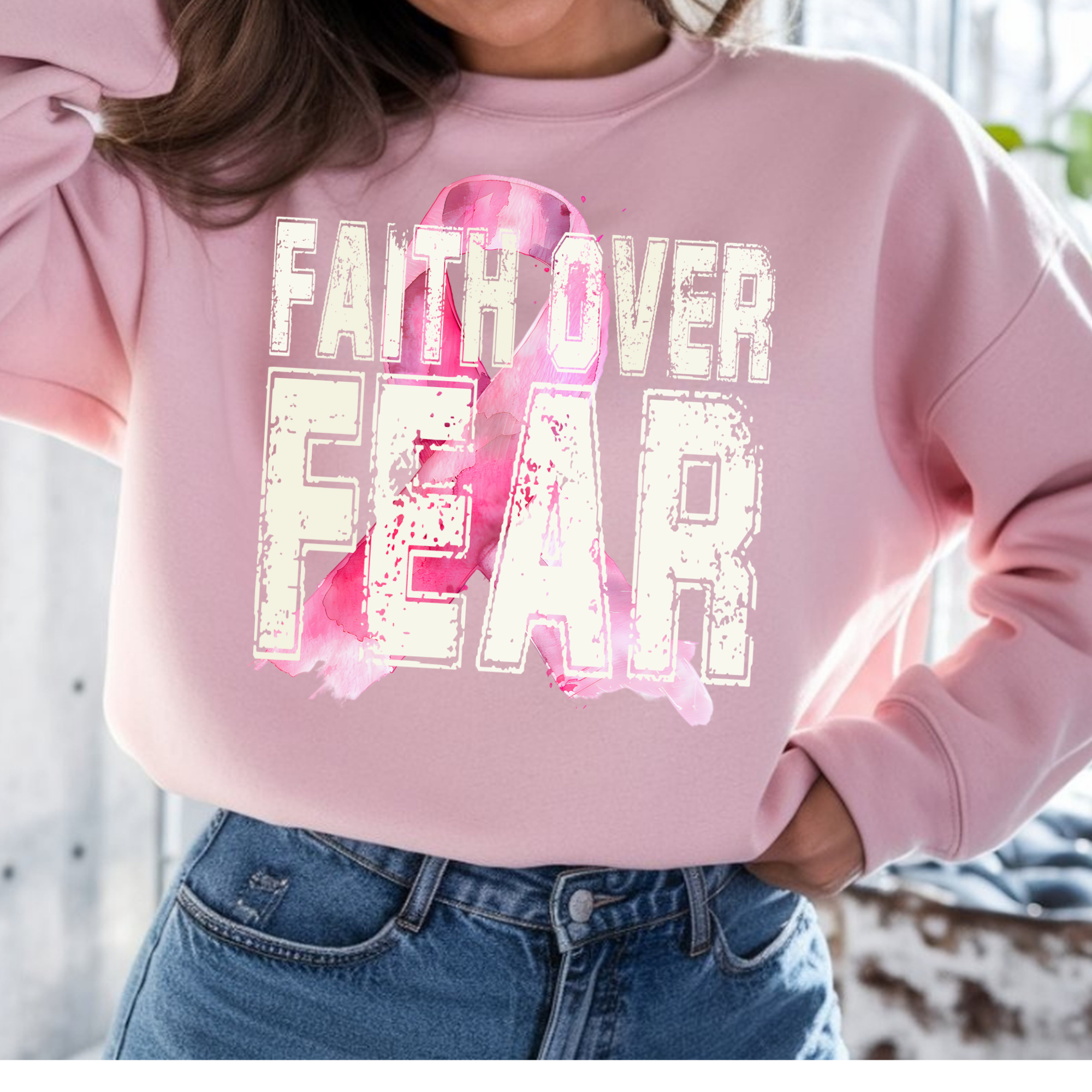 Pink crewneck sweatshirt with distressed 'FAITH OVER FEAR' front graphic