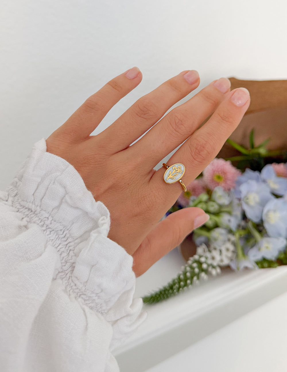 Gold enamel oval floral ring, viewed from the top