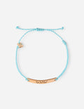 Turquoise braided string bracelet with small shell and bead charms, gold-tone bar
