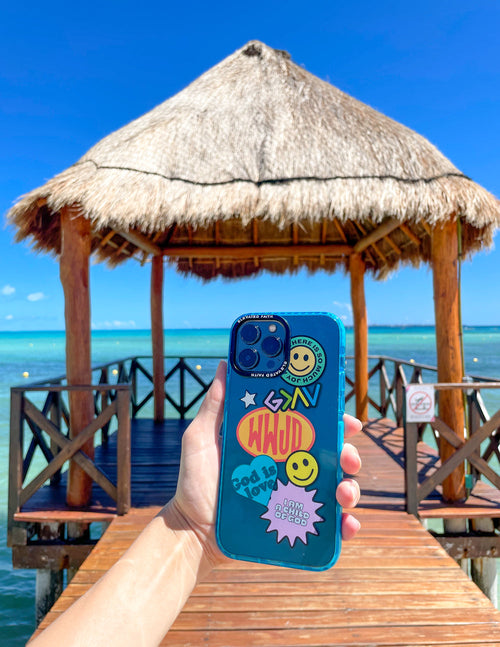 Blue sticker collage phone case held in hand with smiley and starburst graphics