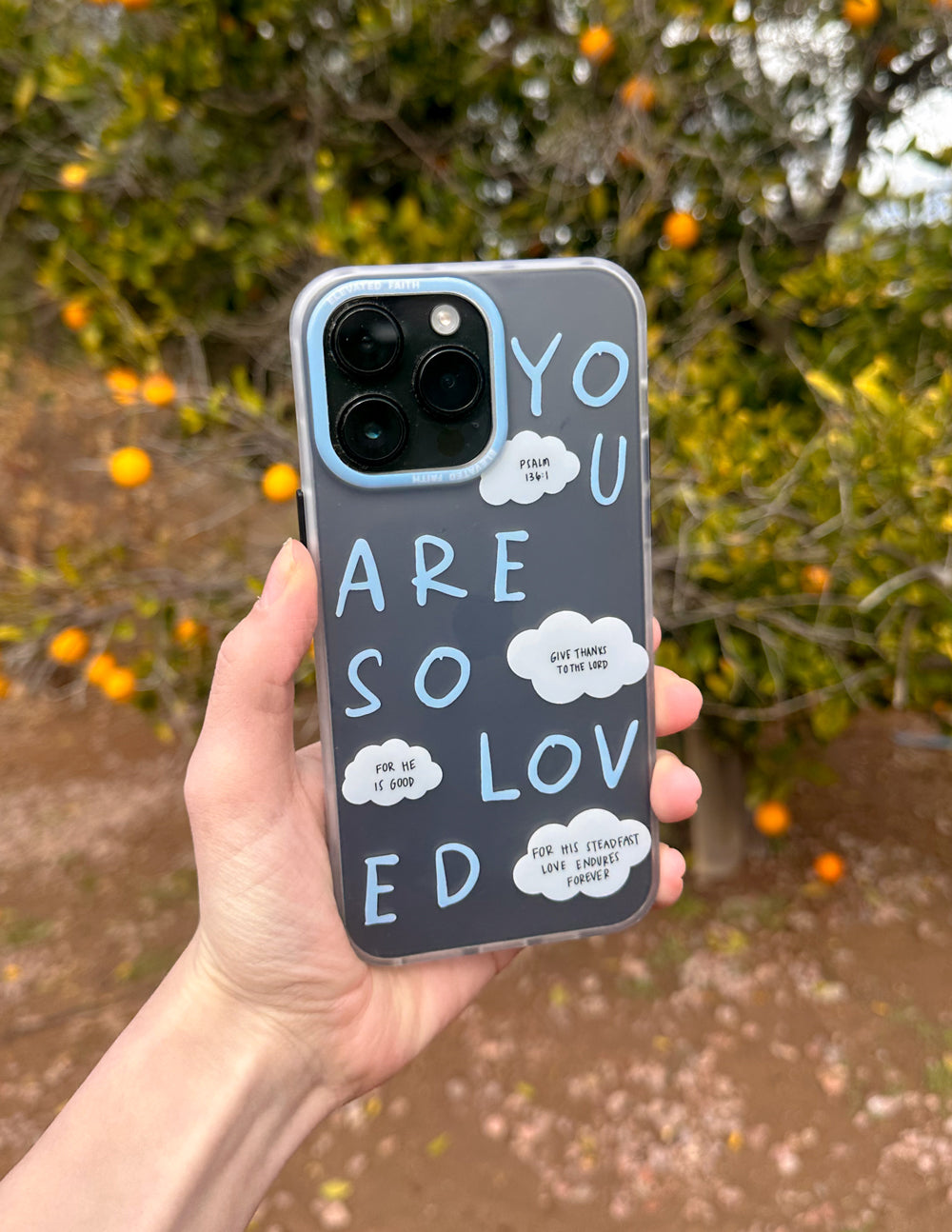 Frosted blue phone case with white heart cloud text and camera cutouts