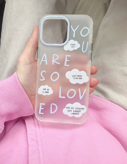 Frosted blue phone case held in hand with white word art and cloud note stickers