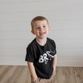 Baby and kids space-themed T-shirt, black with large white “BRO” graphic on chest.
