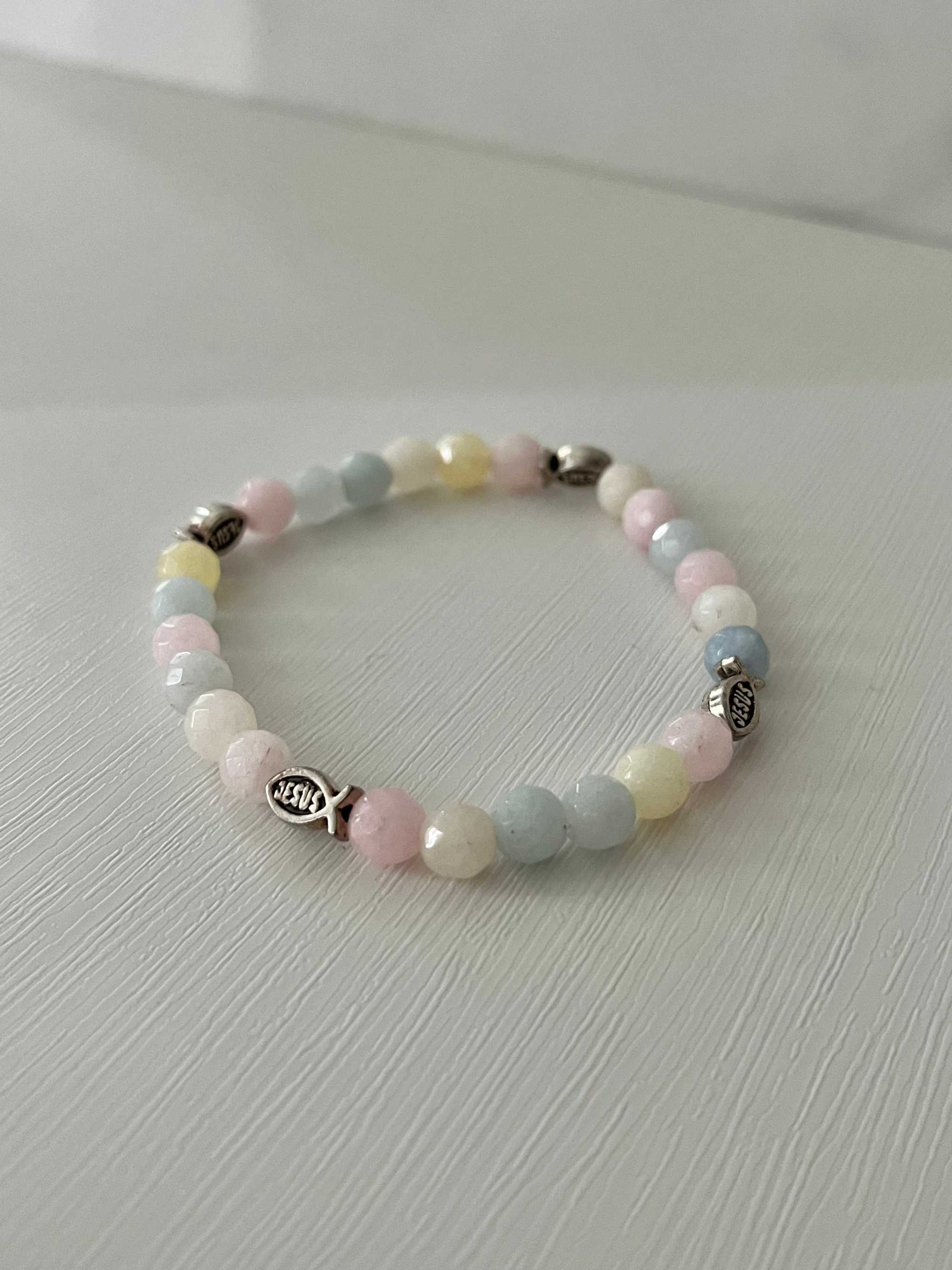 Pastel multicolor bead bracelet with cross charm and round bead pattern