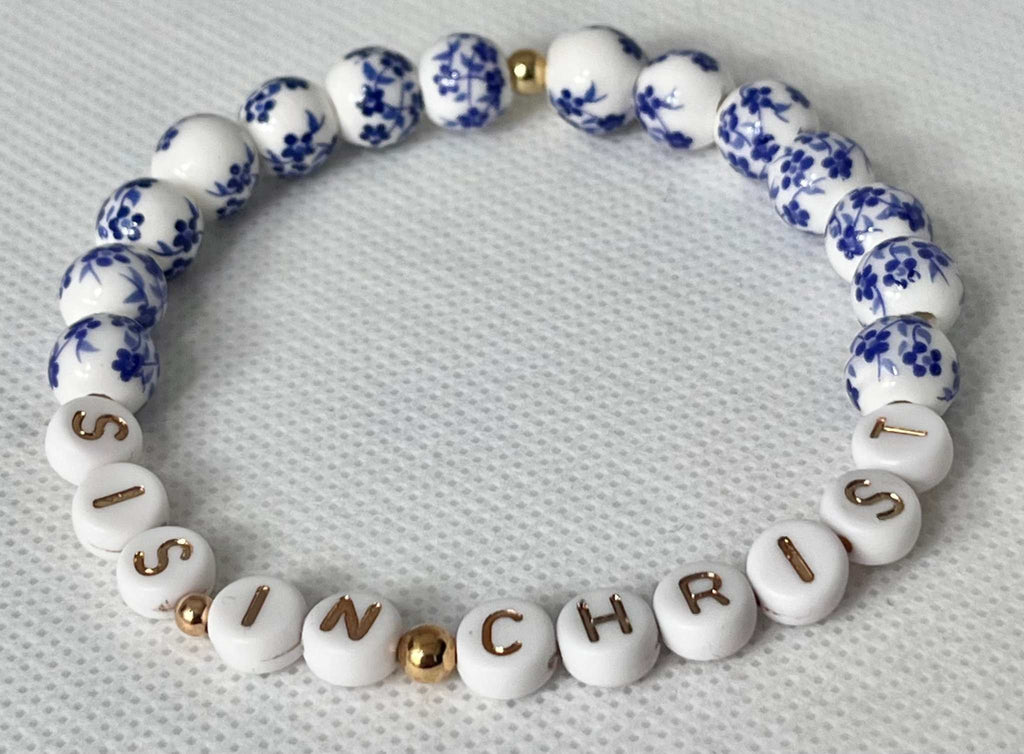 Blue and white beaded bracelet with gold spacers and letters spelling IN CHRIST