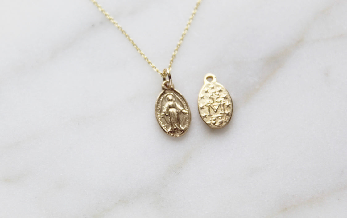 14k gold miraculous medal necklace with oval medal pendant on a fine chain