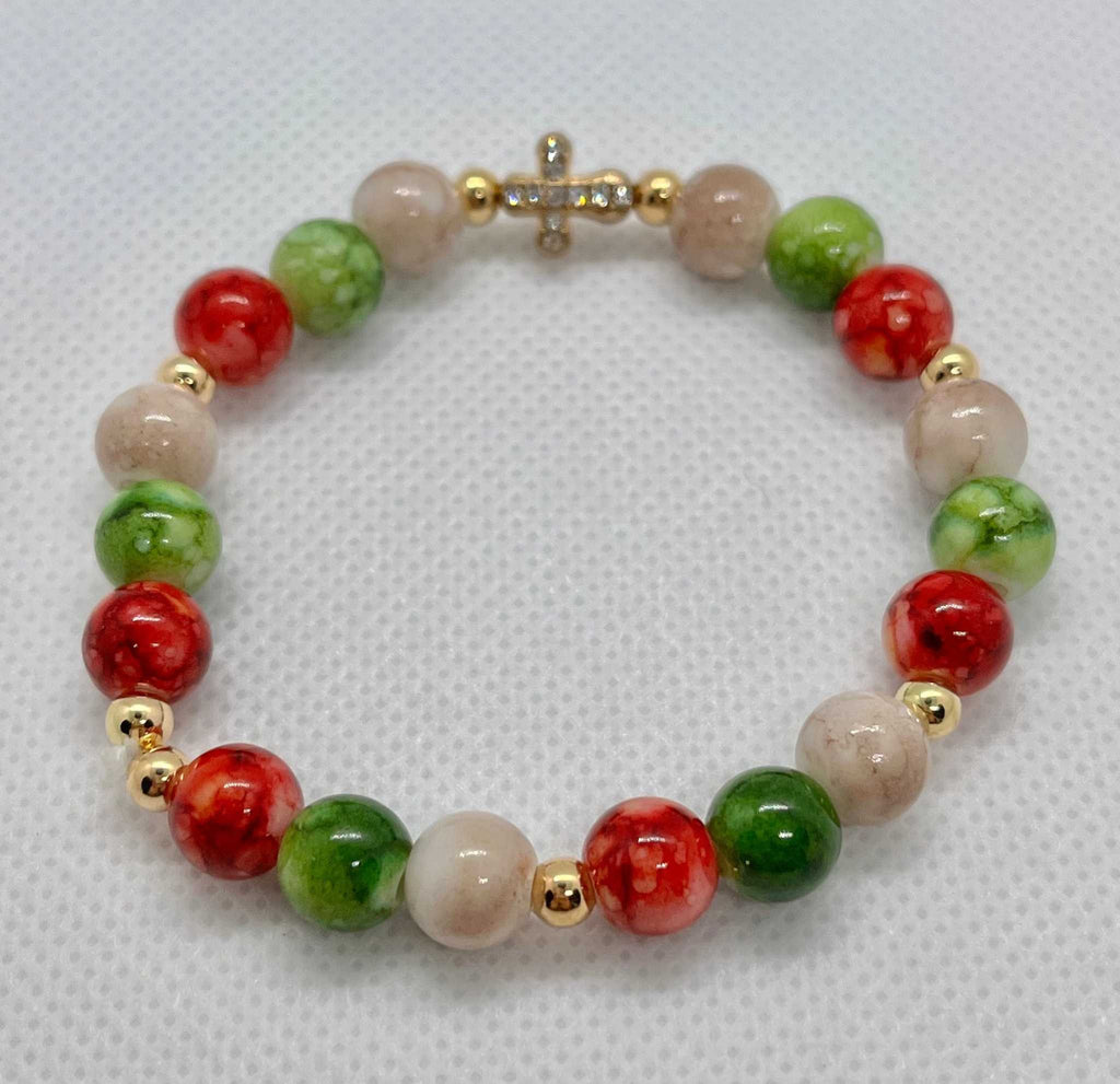 Bead bracelet with marbled beige beads, green and red accents, and a gold jeweled cross