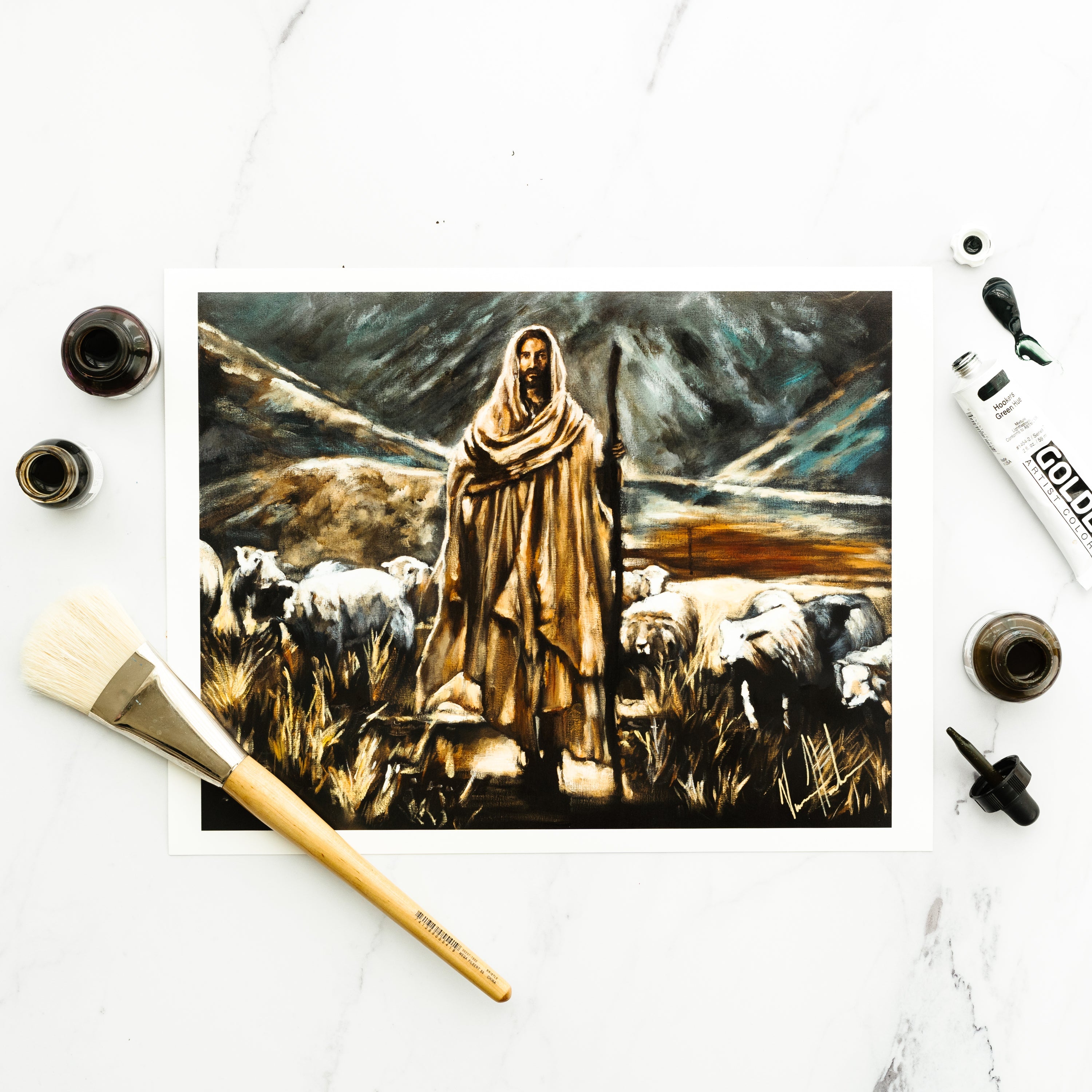 Paper print of robed shepherd with sheep in a field, shown flat