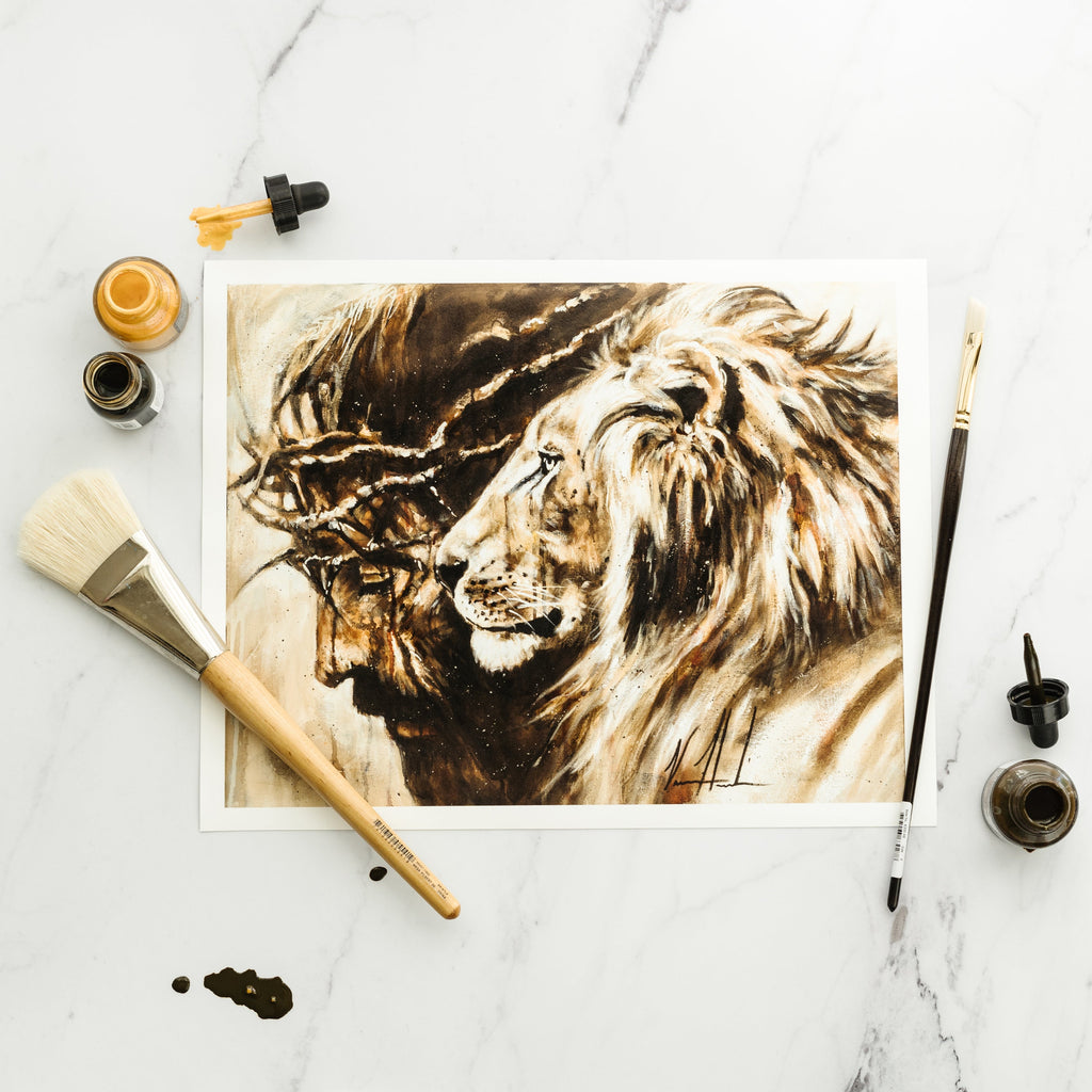 Heaven's Grace lion portrait print with paintbrushes and pigments laid nearby