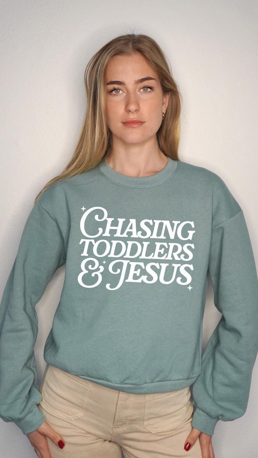 Women’s cropped sweatshirt in teal with Chasing Toddlers & Jesus front graphic
