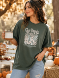 Dark green short-sleeve T-shirt with 'Give Thanks' autumn leaf graphic on front