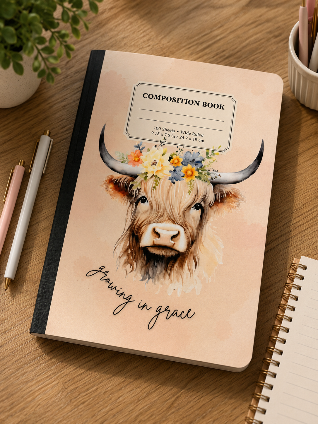 Beige composition book with Highland cow illustration, flowers, and "Growing in grace" text