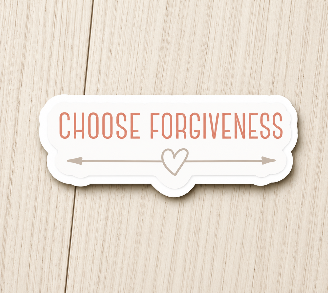 White sticker with orange “Choose Forgiveness” text and a heart between arrows