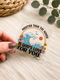 UVDTF decal with ocean wave illustration and floral lettering, held in fingers