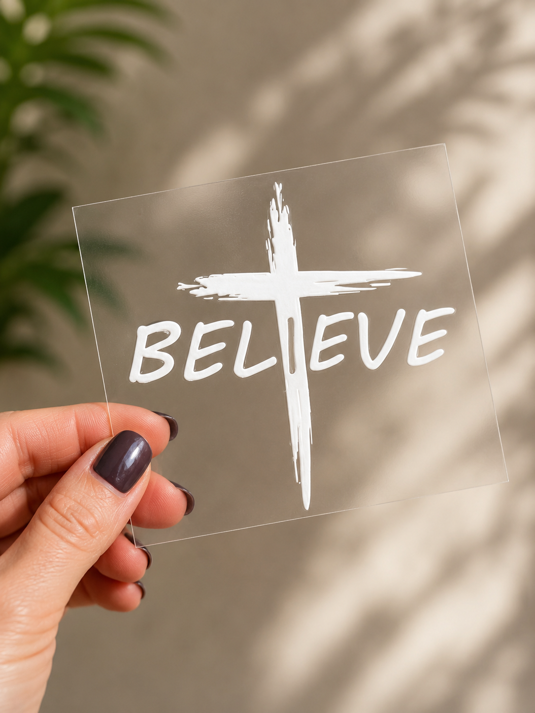 Clear UV DTF decal with white cross and BELIEVE text