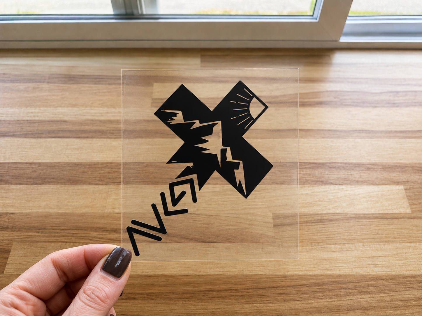 Black cross UV DTF decal with stylized lightning and arrow symbols
