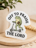 Christian frog sticker with text "Off to Praise the Lord" and frog holding a cross