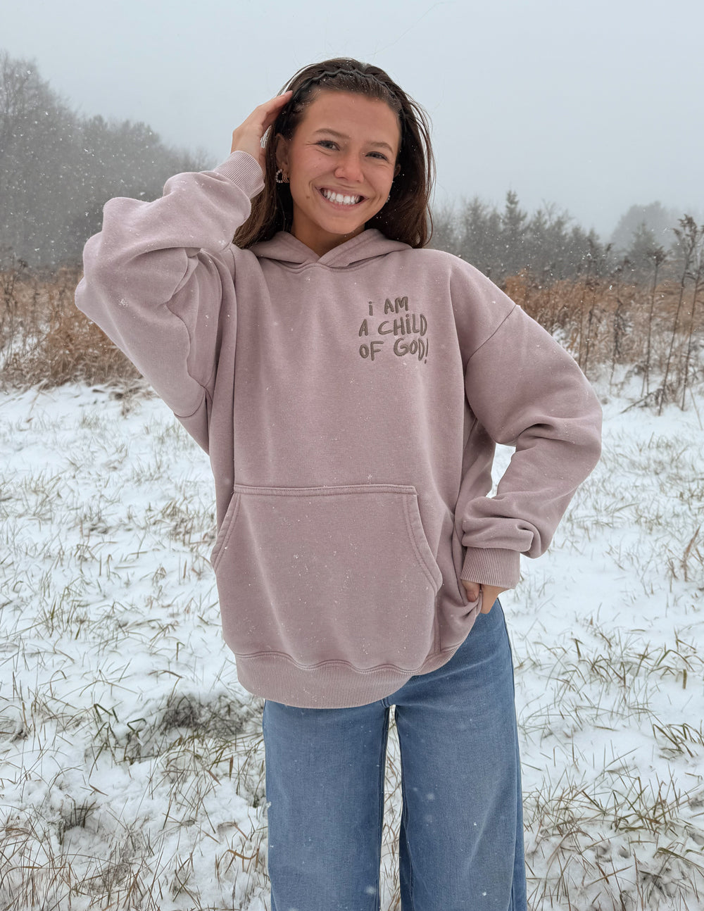 Mauve unisex hoodie with hood up, front graphic print, and pocket