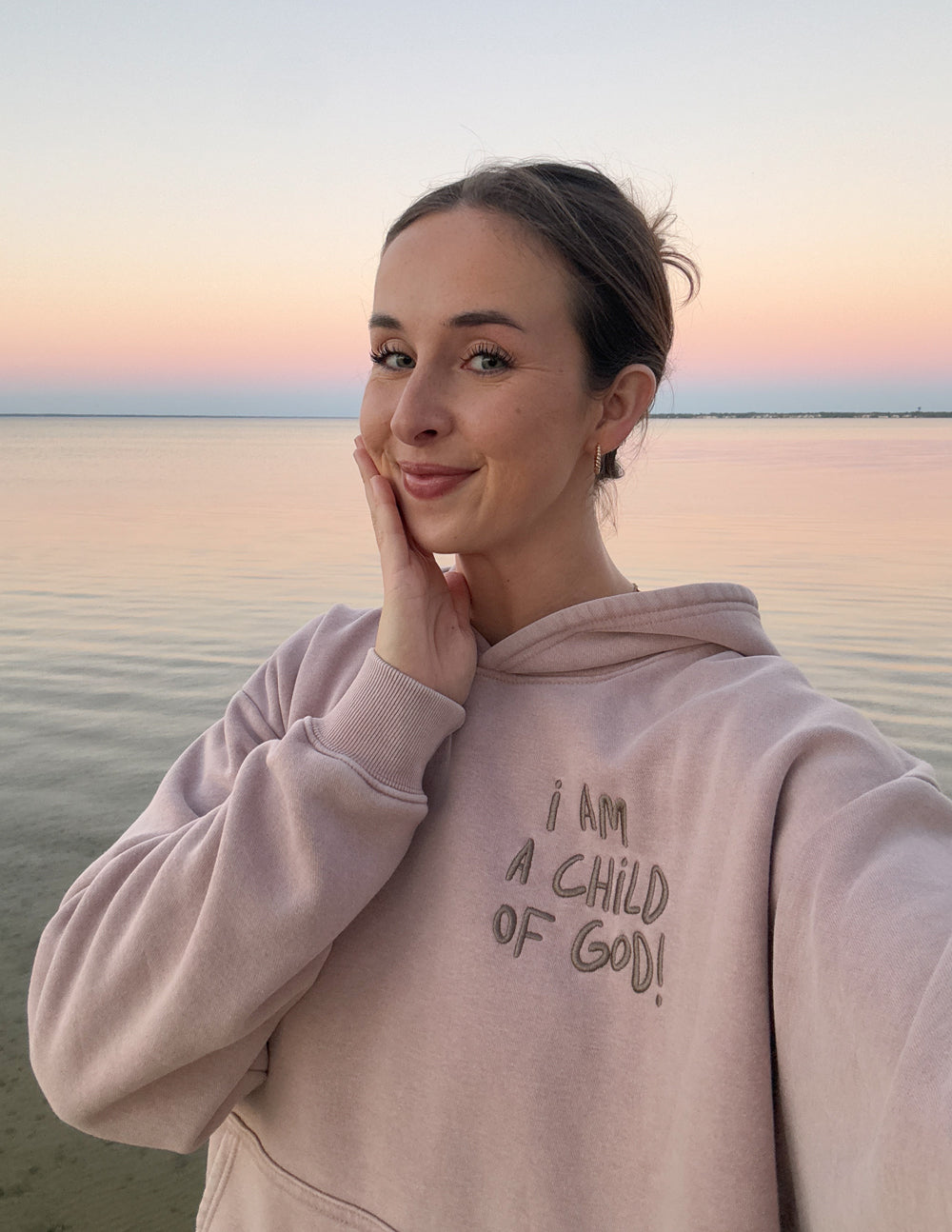 Mauve unisex hoodie with hood up and front graphic print