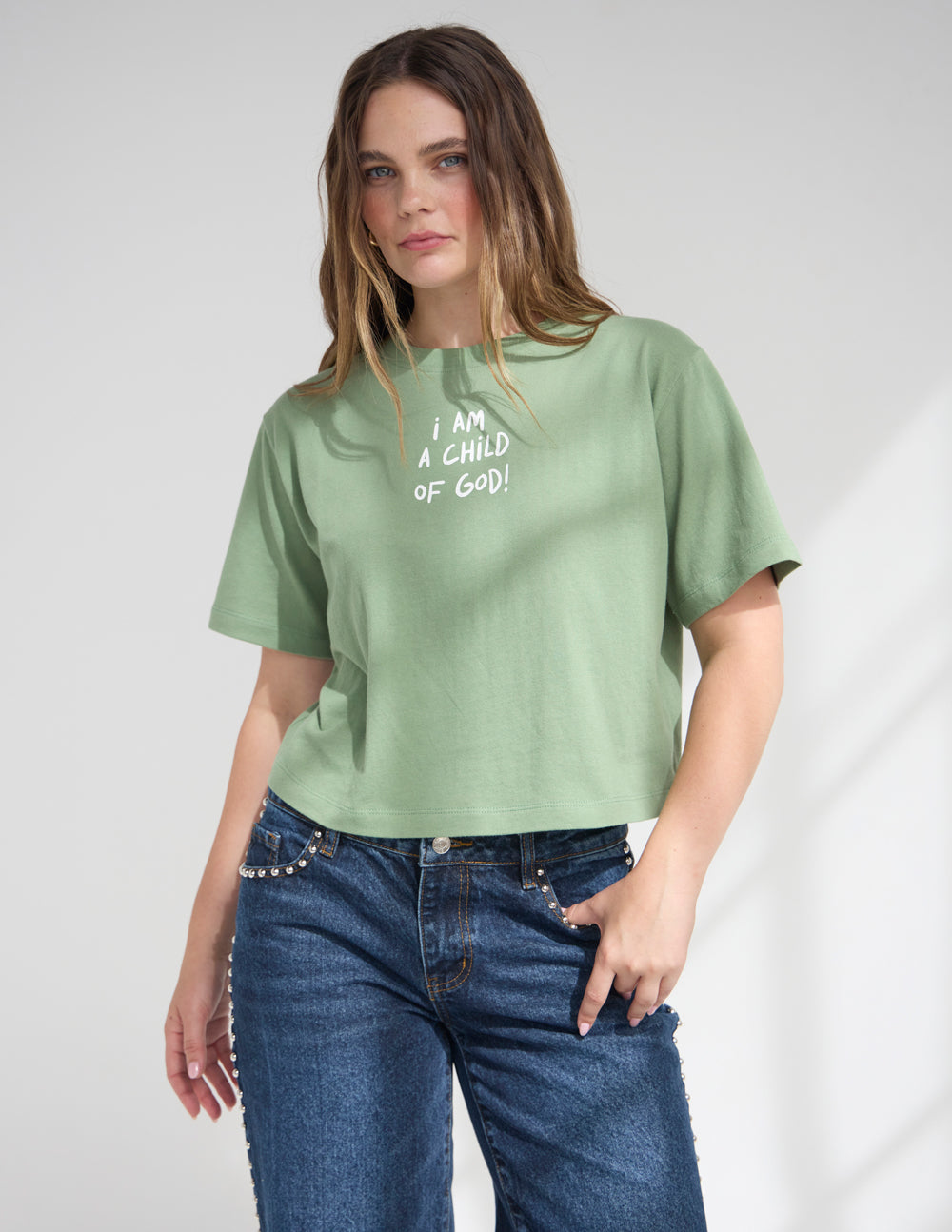 Green cropped women’s tee with short sleeves and “I AM A CHILD OF GOD!” lettering
