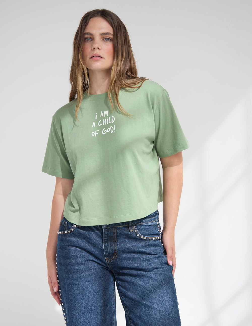 Green cropped women’s tee with crew neck and “I AM A CHILD OF GOD!” graphic text