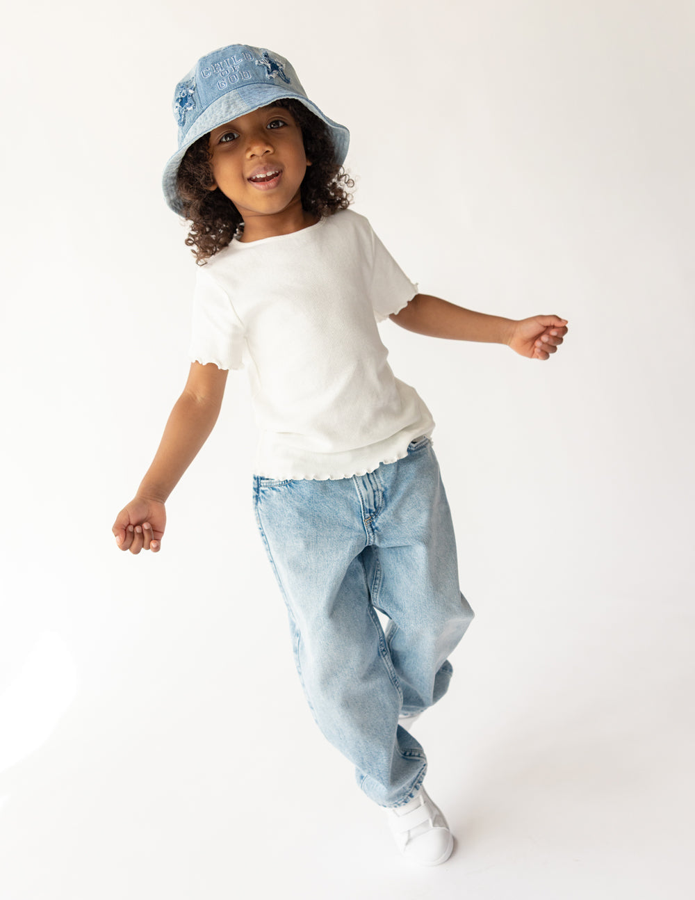 Light blue denim kids bucket hat on child, front logo visible, wide brim