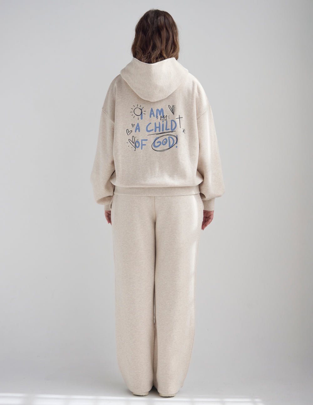 Light beige full-zip hoodie with hood and front graphic text