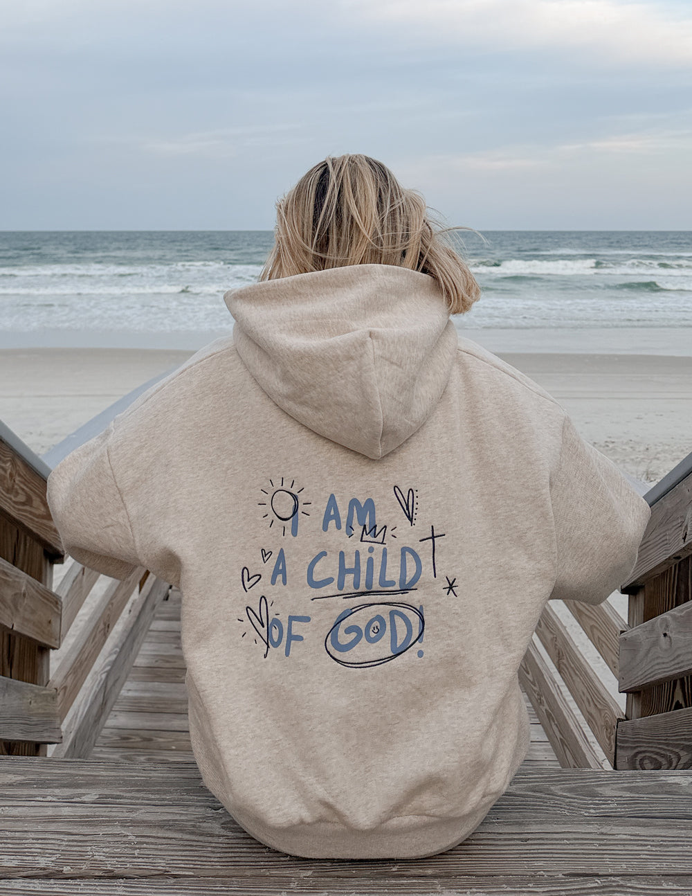 Light beige full-zip hoodie with hood and back graphic text