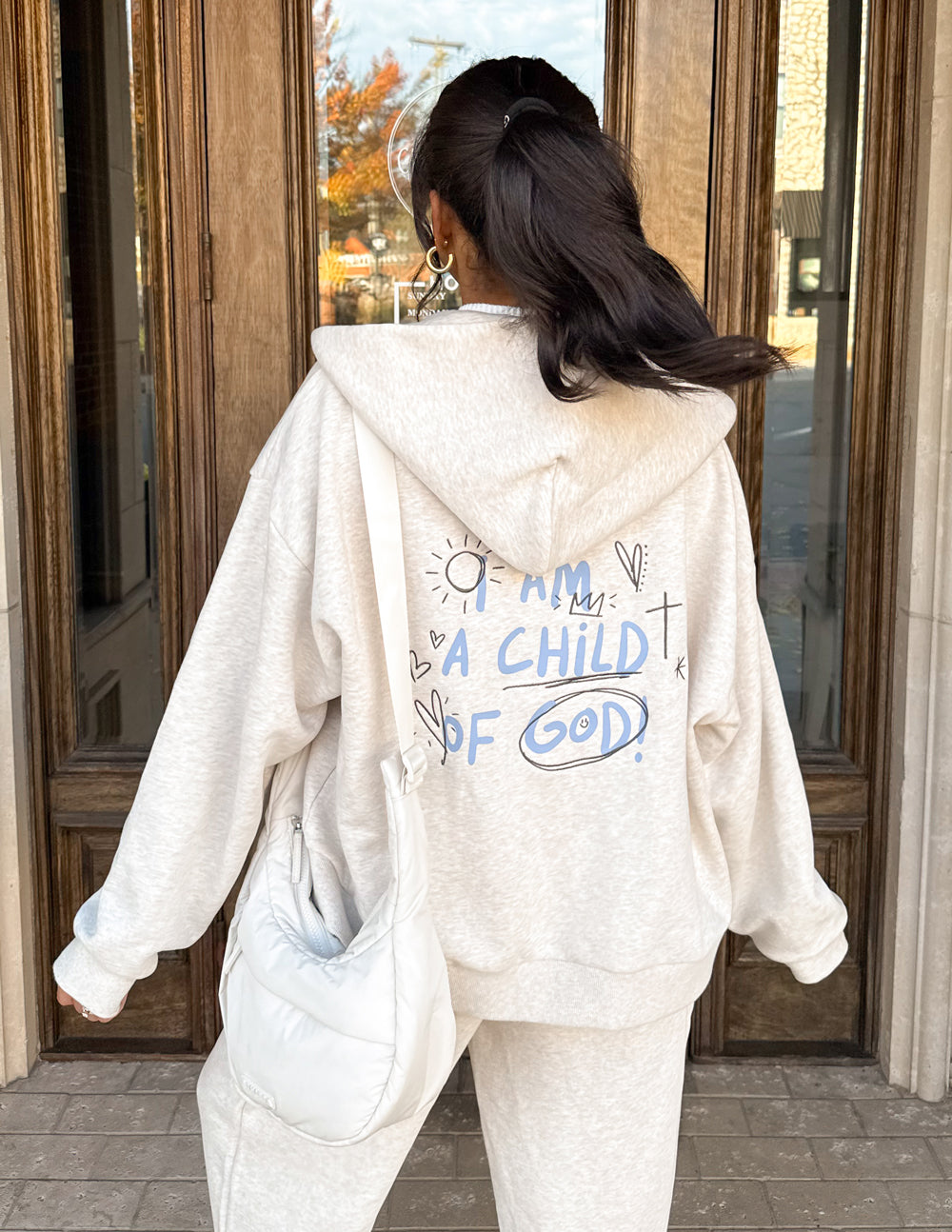 Eggshell full-zip hoodie with back graphic text, hood up