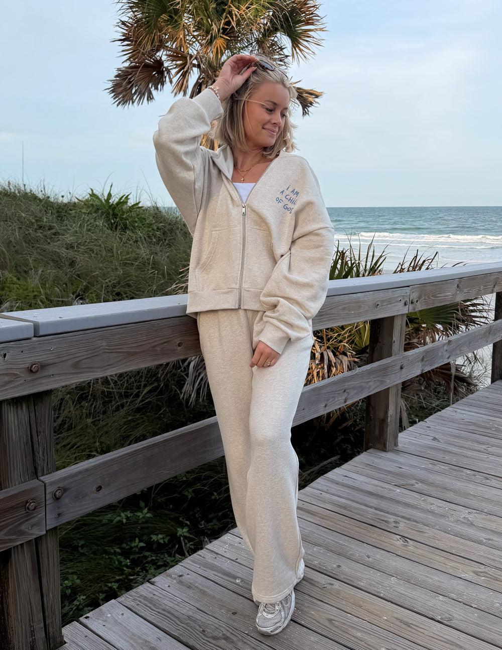 Eggshell full-zip hoodie with side view and chest graphic