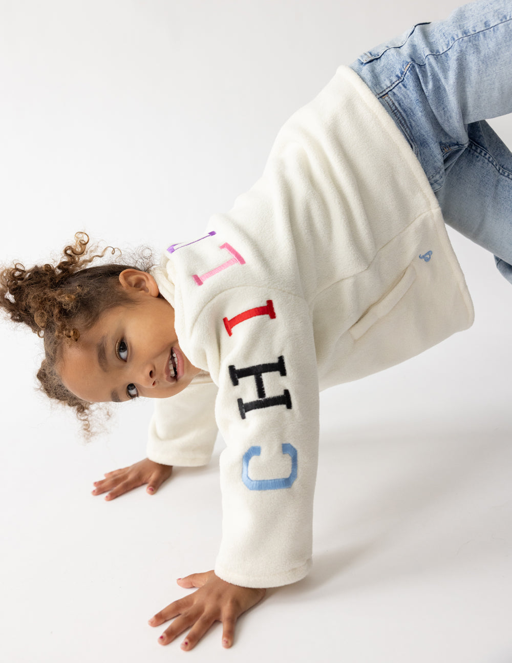 Kids cream fleece pullover with half-zip and multicolor “CHILD OF GOD” on sleeve