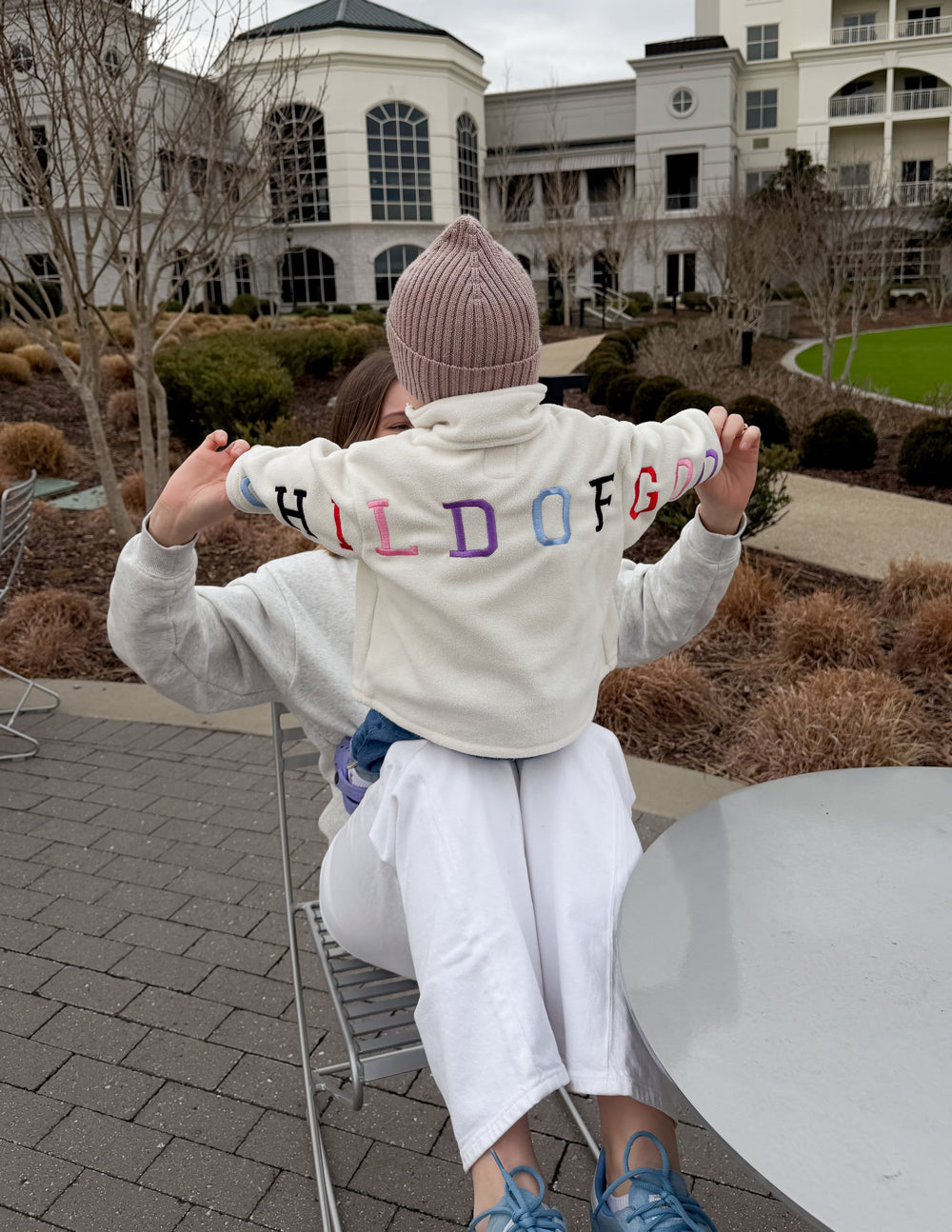 Kids cream fleece pullover with half-zip and multicolor “CHILD OF GOD” logo