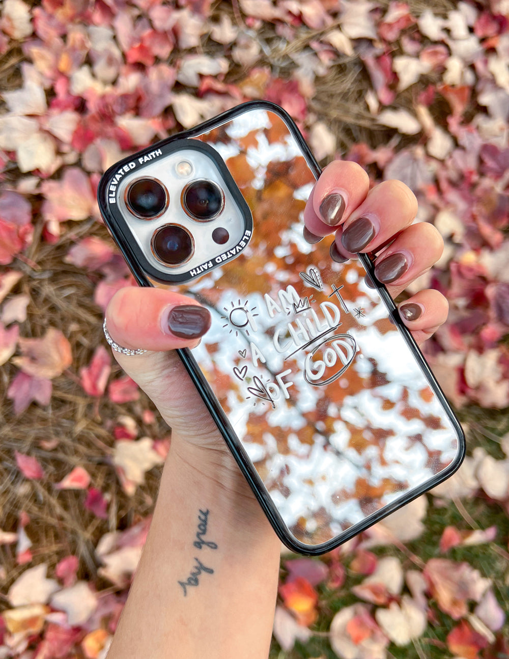 Mirror phone case with black frame, marbled reflective back, and "I AM CHILD OF GOD"