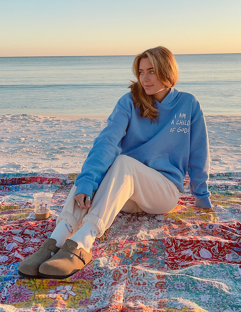 Light blue unisex hoodie with chest graphic and front kangaroo pocket